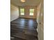 A bright bedroom features windows for natural light and modern flooring at 523 Berry Chase Way, Cary, NC 27519