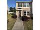 Charming home exterior with brick accents, manicured bushes, and a welcoming front entrance at 523 Berry Chase Way, Cary, NC 27519