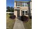 Charming brick front exterior featuring brown shutters and a covered entryway with the house number 523 at 523 Berry Chase Way, Cary, NC 27519