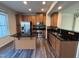 Open kitchen features wood cabinets, backsplash, and new flooring at 523 Berry Chase Way, Cary, NC 27519