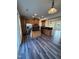 The open kitchen features stainless steel appliances, wood cabinets, and an island with granite countertops at 523 Berry Chase Way, Cary, NC 27519