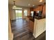 The open kitchen features stainless steel appliances, wood cabinets, and an island with granite countertops at 523 Berry Chase Way, Cary, NC 27519