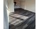 Open-concept living room with new dark-gray wood-look flooring and classic trim at 523 Berry Chase Way, Cary, NC 27519