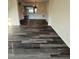 Open-concept living room with new dark-gray wood-look flooring and classic trim at 523 Berry Chase Way, Cary, NC 27519