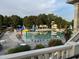 Resort-style pool area with lounge chairs, umbrellas, and a waterslide for ultimate relaxation and fun at 523 Berry Chase Way, Cary, NC 27519