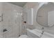 Modern bathroom with a glass shower, white vanity, and stylish round mirror at 534 Elm Ave, Wake Forest, NC 27587