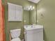 Bathroom features a vanity, decorative mirror, overhead lighting, and a toilet at 534 Elm Ave, Wake Forest, NC 27587