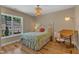 Cozy bedroom with hardwood floors, natural light, and chandelier at 534 Elm Ave, Wake Forest, NC 27587
