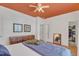 Bright bedroom features terra cotta floors, a decorative dresser and an ensuite bathroom at 534 Elm Ave, Wake Forest, NC 27587