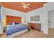 Bright bedroom features terra cotta floors, unique orange ceiling, and decorative headboard at 534 Elm Ave, Wake Forest, NC 27587
