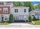 Charming townhouse with landscaped front yard and manicured bushes, featuring a neutral color scheme and inviting curb appeal at 534 Elm Ave, Wake Forest, NC 27587