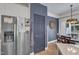 Bright kitchen area features stainless steel refrigerator and leads to a dining area with natural light at 534 Elm Ave, Wake Forest, NC 27587