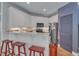 Bright kitchen with white cabinets, a breakfast bar with red stools, and stainless steel appliances at 534 Elm Ave, Wake Forest, NC 27587