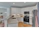 Modern kitchen with white cabinets, mosaic backsplash, stainless steel appliances, and ample counter space at 534 Elm Ave, Wake Forest, NC 27587