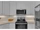 Modern kitchen with white cabinets, stainless steel appliances, and ample countertop space at 534 Elm Ave, Wake Forest, NC 27587