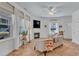 Bright living room showcasing large windows, neutral decor, a cozy fireplace, and warm terra cotta flooring at 534 Elm Ave, Wake Forest, NC 27587