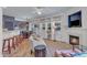 Inviting living room with brick floors, a fireplace, natural light, and a seamless dining area at 534 Elm Ave, Wake Forest, NC 27587