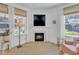 Cozy living room with fireplace, terra cotta flooring, neutral decor, and plenty of natural light at 534 Elm Ave, Wake Forest, NC 27587