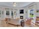 Bright living room with terra cotta tile, fireplace, neutral furniture, and an abundance of natural light at 534 Elm Ave, Wake Forest, NC 27587