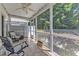 Relaxing screened porch with ceiling fan and comfortable seating, overlooking lush greenery at 534 Elm Ave, Wake Forest, NC 27587