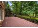 Large outdoor deck with wood floors, overlooking serene trees and greenery at 541 The Preserve Trail Trl, Chapel Hill, NC 27517