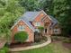 Stately brick residence surrounded by beautiful greenery, creating a private and serene setting at 541 The Preserve Trail Trl, Chapel Hill, NC 27517
