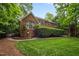 Lush backyard featuring a brick home with large windows and a manicured lawn, perfect for outdoor enjoyment at 541 The Preserve Trail Trl, Chapel Hill, NC 27517
