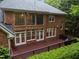 Back of a brick home featuring a spacious deck with multiple windows, ideal for entertaining or relaxation at 541 The Preserve Trail Trl, Chapel Hill, NC 27517