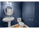 Powder bathroom featuring a pedestal sink, mirror and blue painted walls at 541 The Preserve Trl, Chapel Hill, NC 27517