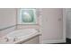 Bathroom features a luxurious soaking tub with decorative tiled surround and stained glass window at 541 The Preserve Trl, Chapel Hill, NC 27517