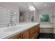 Bathroom featuring a double vanity, a soaking tub with tile surround, and ample storage at 541 The Preserve Trl, Chapel Hill, NC 27517