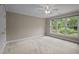 Carpeted bedroom offering good lighting and large window overlooking front yard at 541 The Preserve Trl, Chapel Hill, NC 27517