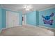 This bedroom features bright blue walls, neutral carpet, and a playful Stitch themed accent wall at 541 The Preserve Trl, Chapel Hill, NC 27517