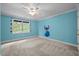 Bedroom with blue walls and ceiling fan, also featuring a Stitch wall sticker at 541 The Preserve Trl, Chapel Hill, NC 27517