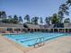 A large, sparkling community pool with plenty of lounge chairs and umbrellas for residents to enjoy at 541 The Preserve Trl, Chapel Hill, NC 27517
