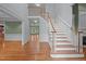 Open foyer with beautiful hardwood floors and a staircase with white and wood railings at 541 The Preserve Trl, Chapel Hill, NC 27517
