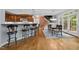 Open concept with island seating near the dining room and a wooden staircase at 541 The Preserve Trl, Chapel Hill, NC 27517
