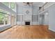 Living room with fireplace, built-ins, hardwood floors, and a wall of windows at 541 The Preserve Trl, Chapel Hill, NC 27517