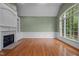 Living room with large windows, a fireplace, hardwood floors and custom trim at 541 The Preserve Trl, Chapel Hill, NC 27517
