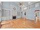 Spacious living room featuring hardwood floors, fireplace with built-ins, and a soaring ceiling with a ceiling fan at 541 The Preserve Trl, Chapel Hill, NC 27517