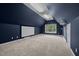 This in-home media room comes equipped with a projector, a projector screen, and a window to the outside at 541 The Preserve Trl, Chapel Hill, NC 27517