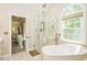 Elegant bathroom featuring a modern glass shower and a soaking tub at 5601 Jomali Dr, Durham, NC 27705