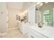 Bright bathroom featuring a double vanity and stylish mirrors at 5601 Jomali Dr, Durham, NC 27705