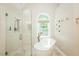 Bathroom showcasing a glass shower, soaking tub, and elegant fixtures at 5601 Jomali Dr, Durham, NC 27705