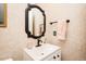 Cozy bathroom featuring a vanity with modern fixtures, mirror, and neutral wallpaper at 5601 Jomali Dr, Durham, NC 27705