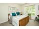 Cozy bedroom with a wood frame bed, teal pillows, and natural light at 5601 Jomali Dr, Durham, NC 27705