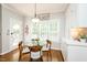 Sunny breakfast nook featuring a glass table and chairs, with natural light and views of backyard at 5601 Jomali Dr, Durham, NC 27705