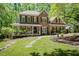 Charming brick home boasts a beautiful landscaped front yard and a welcoming porch at 5601 Jomali Dr, Durham, NC 27705