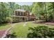 Charming brick home boasts a beautiful landscaped front yard and a welcoming porch at 5601 Jomali Dr, Durham, NC 27705