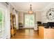 Bright home office with hardwood floors, white brick wall, and decorative lighting at 5601 Jomali Dr, Durham, NC 27705